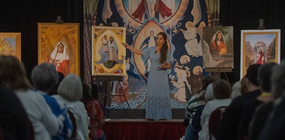 Kate Capato speaking in front of original works of sacred art