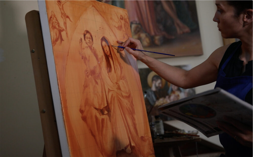 catholic painter creating a painting of Jesus and Mary
